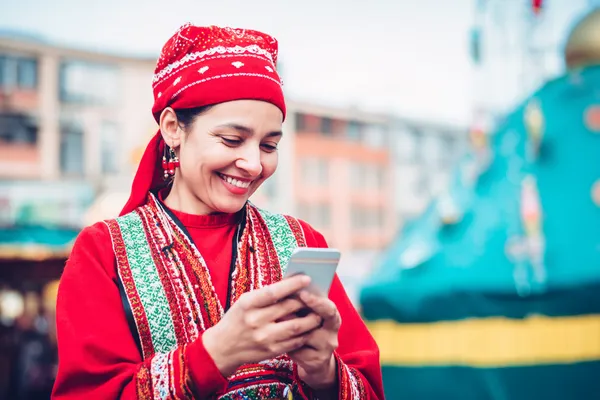 A young woman relaxing with her phone while dynamic casino elements float around her, illustrating the smooth mobile experience offered by the CK6667 app.